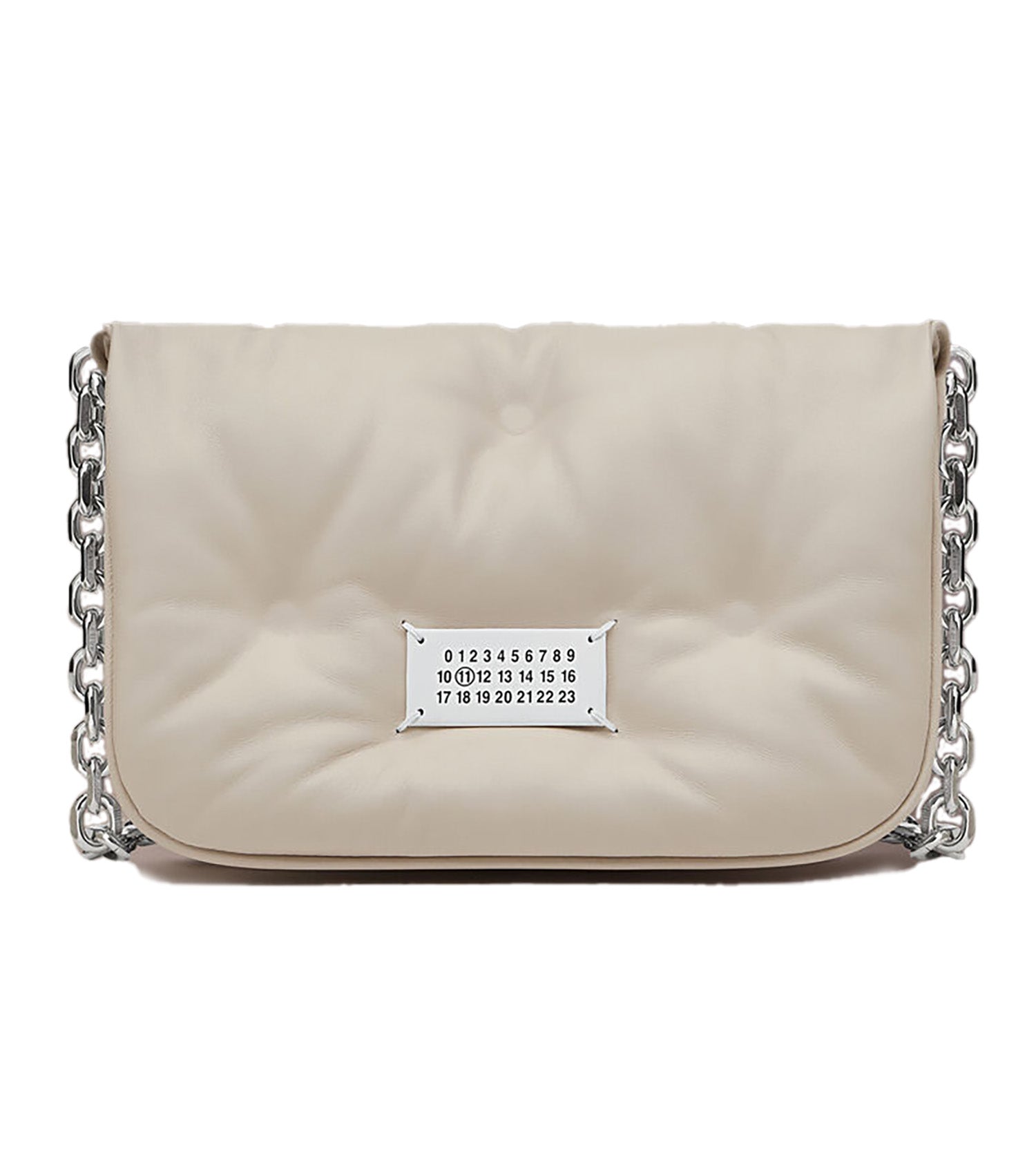 The New Lock square bag is crafted from goat leather and linen. It is characterised by its indicator lock founded in everyday associations. The lock represents the house code of inverted snobbery – the act of transposing the placement of fine and humble materials, giving new value to the piece.