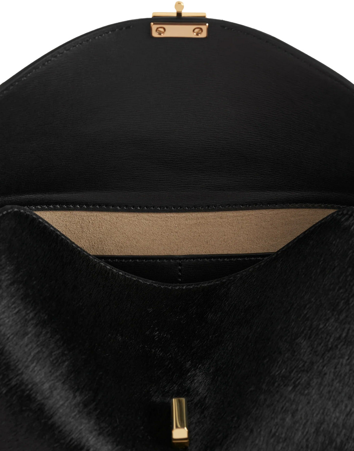 Close-up of a black handbag with gold hardware on a white background