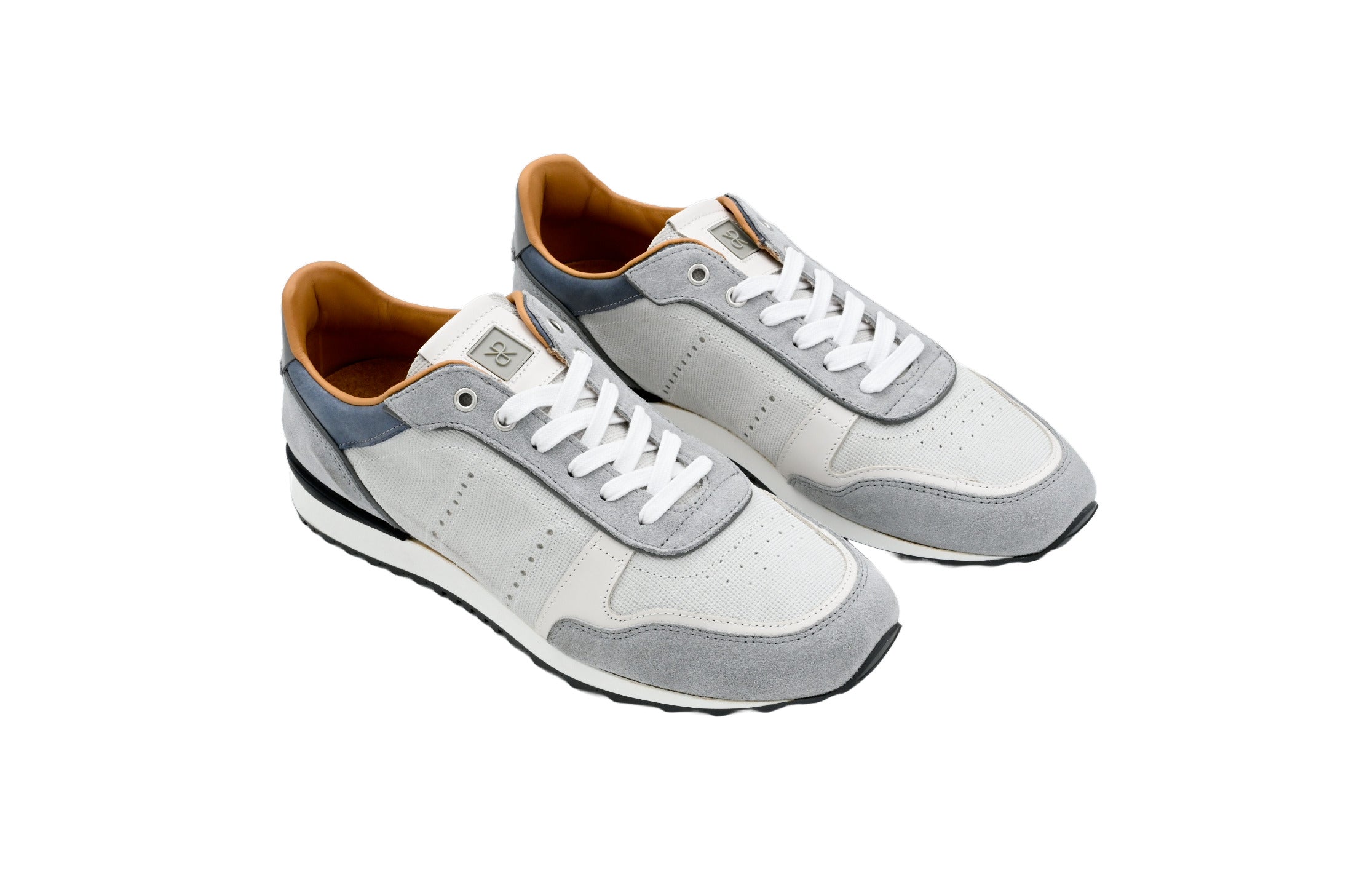 Pair of gray sneakers with white laces on a white background