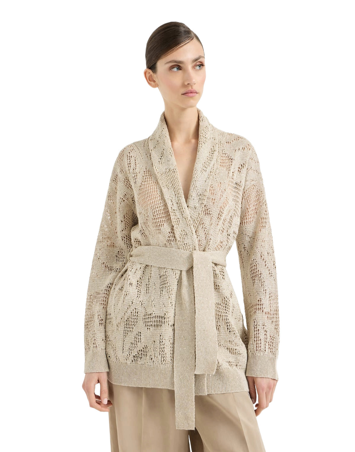 Woman wearing a beige lace cardigan on a white background