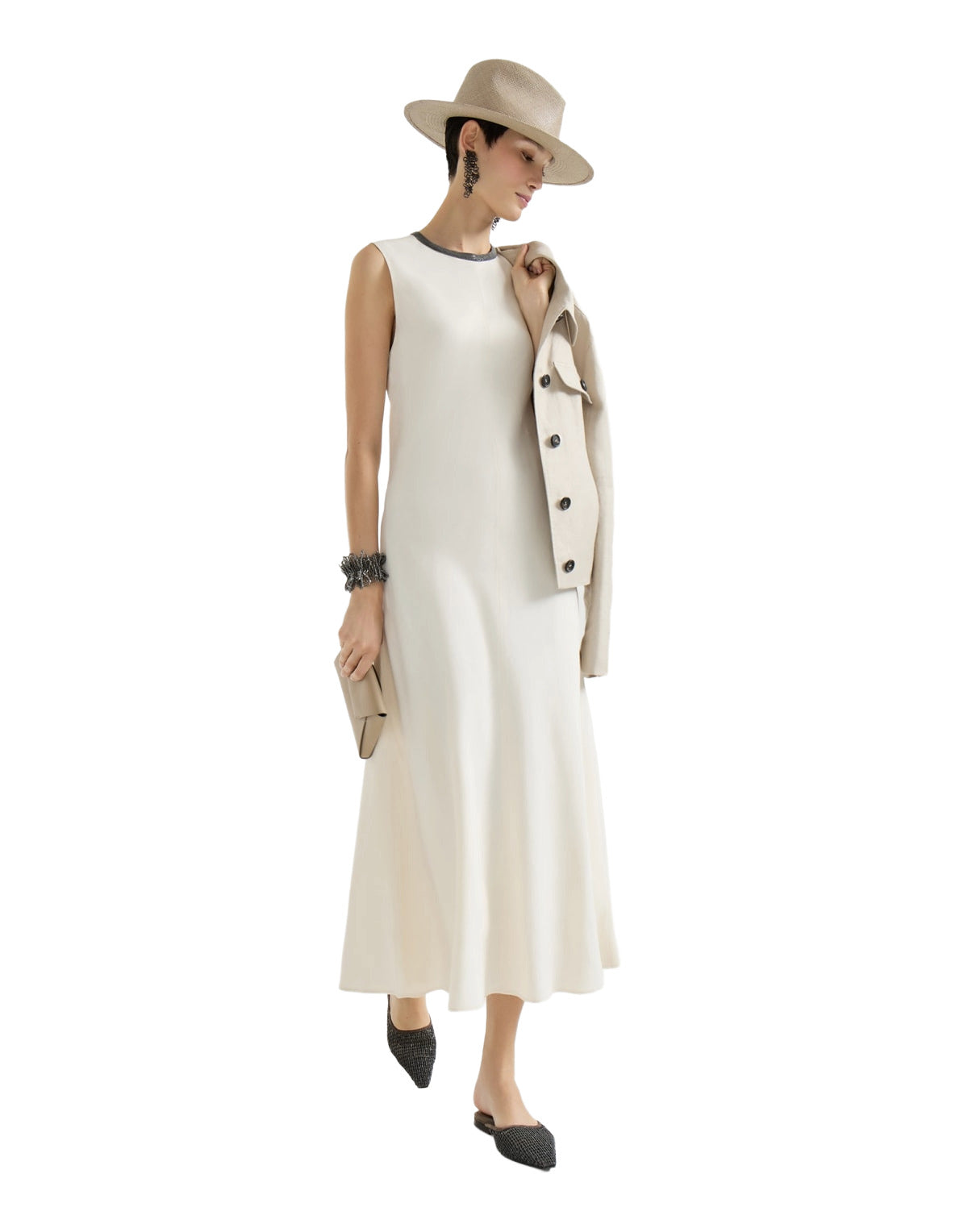Woman wearing a white sleeveless dress with a beige jacket and hat on a white background
