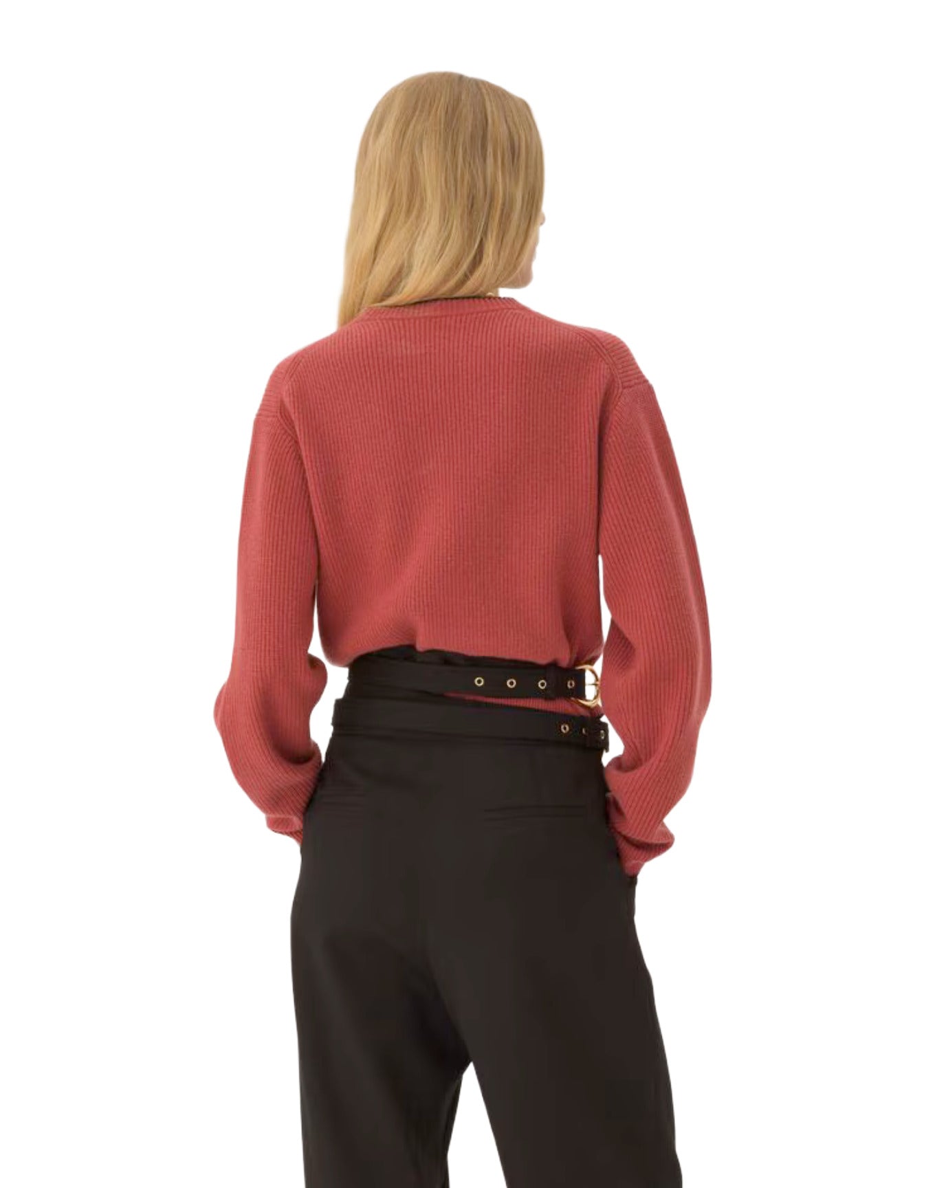 Person wearing a red sweater and black pants on a white background