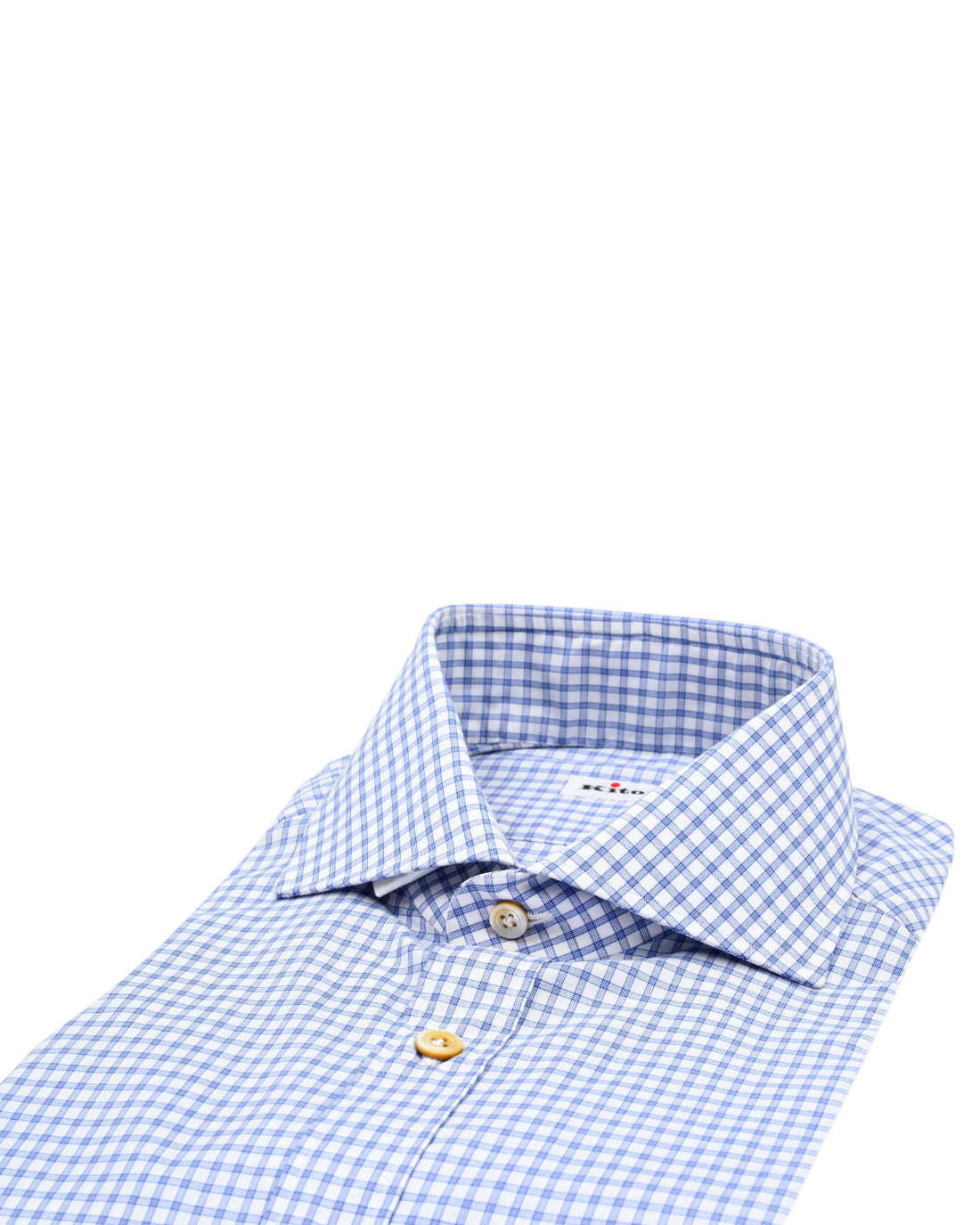 
Folded light blue and white gingham check button down dress shirt with pointed collar and contrasting tan buttons on a clean white background
