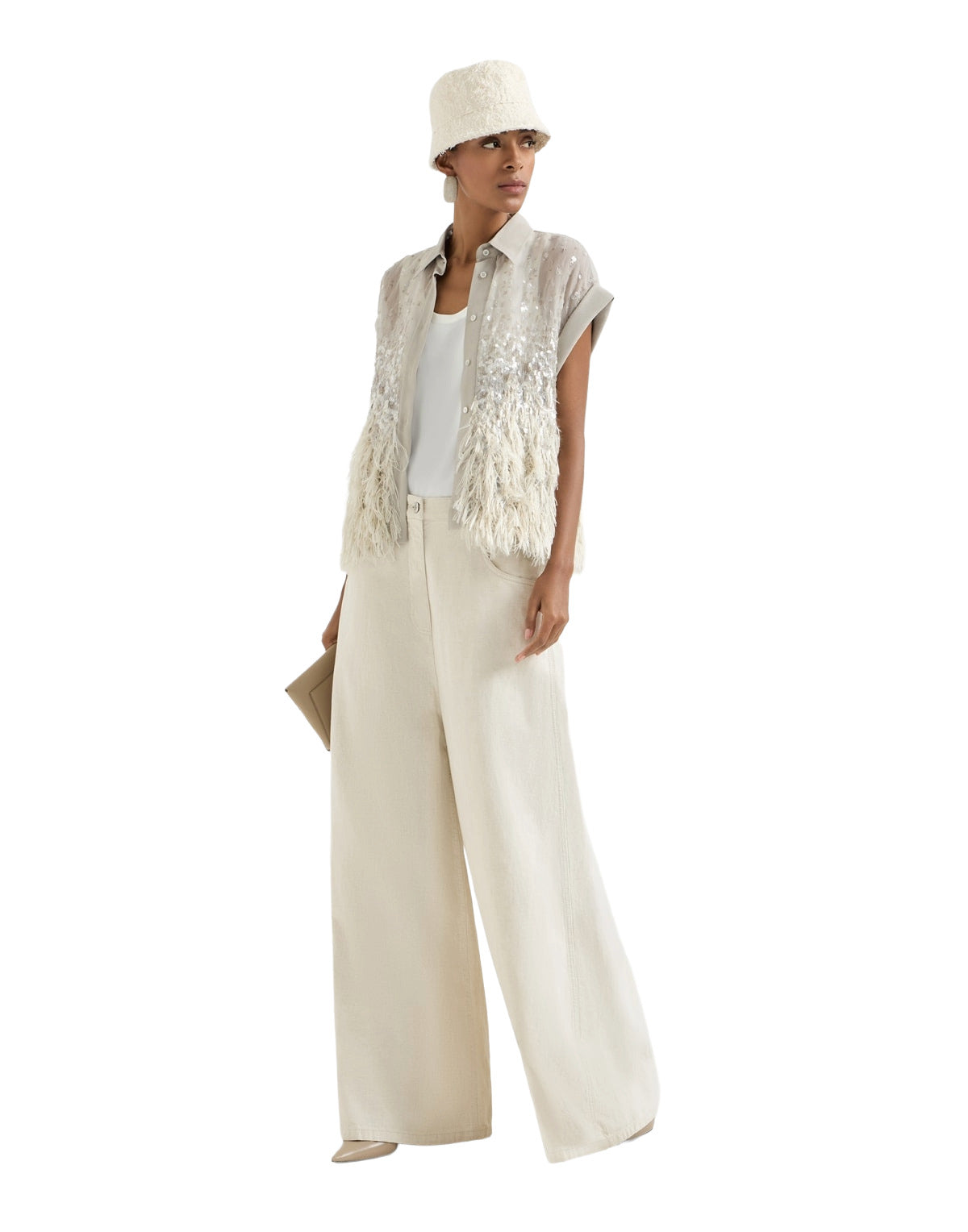 Woman wearing a white outfit with a textured vest and wide-leg pants on a white background