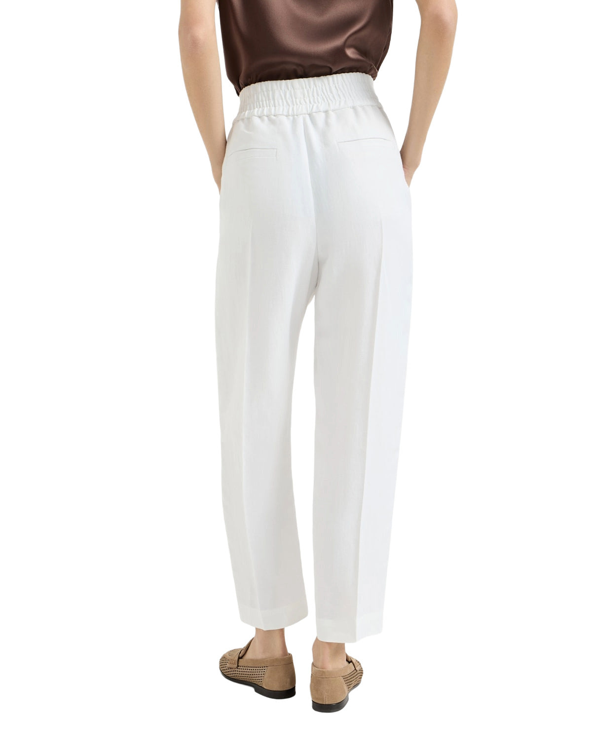 White pants worn by a person on a white background