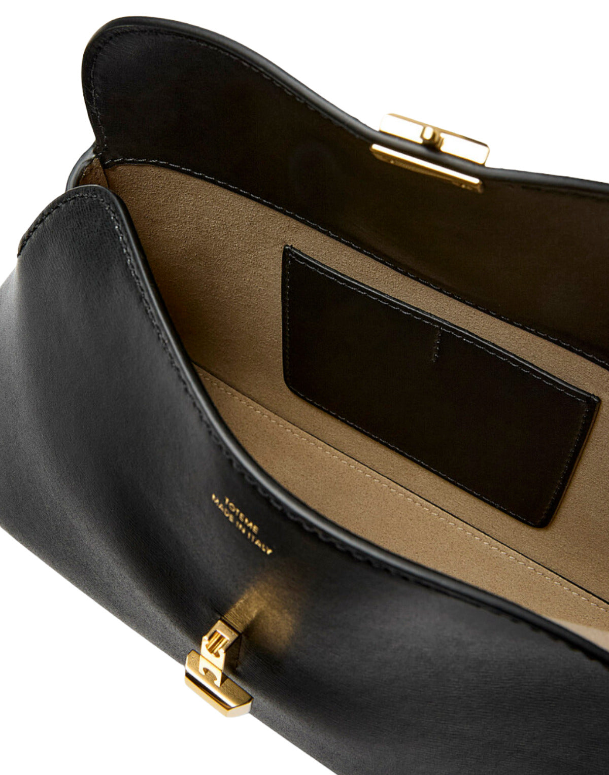 Close-up of a black leather handbag with gold hardware on a white background
