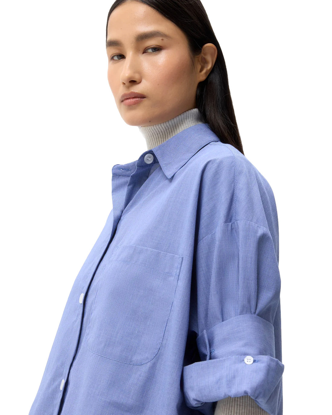 Girl wearing blue shirt with long hair