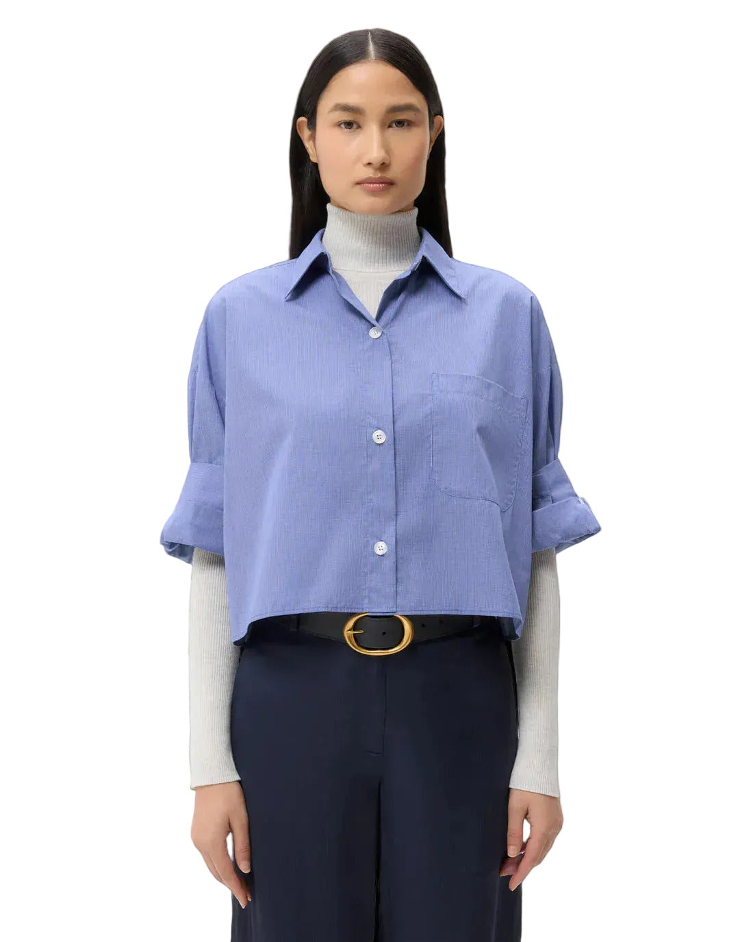 Girl wearing blue TWP Next Ex dress shirt styled with turtle neck underneath