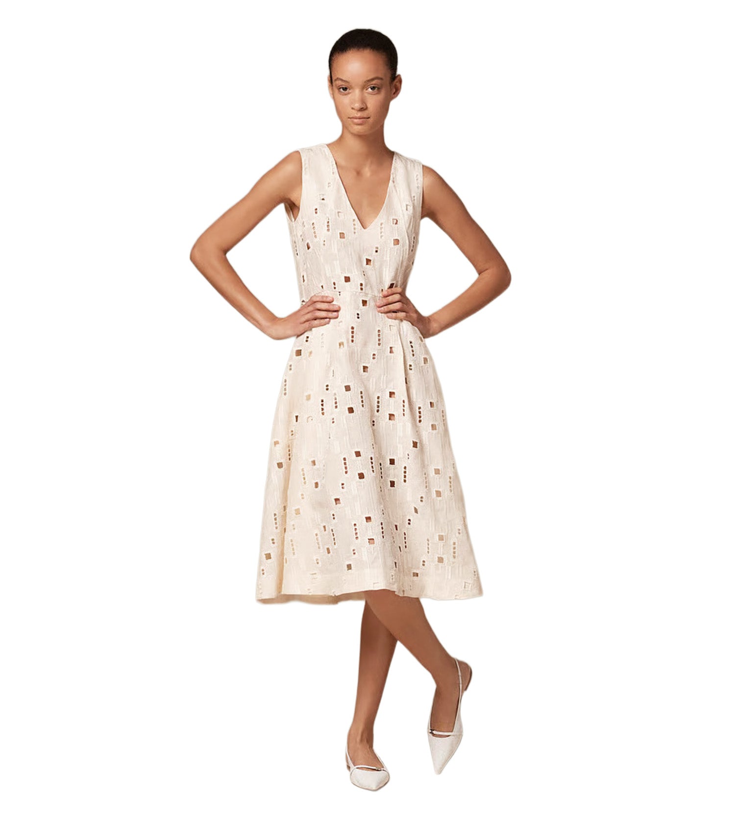 Woman wearing a white dress with eyelet pattern by Kiton