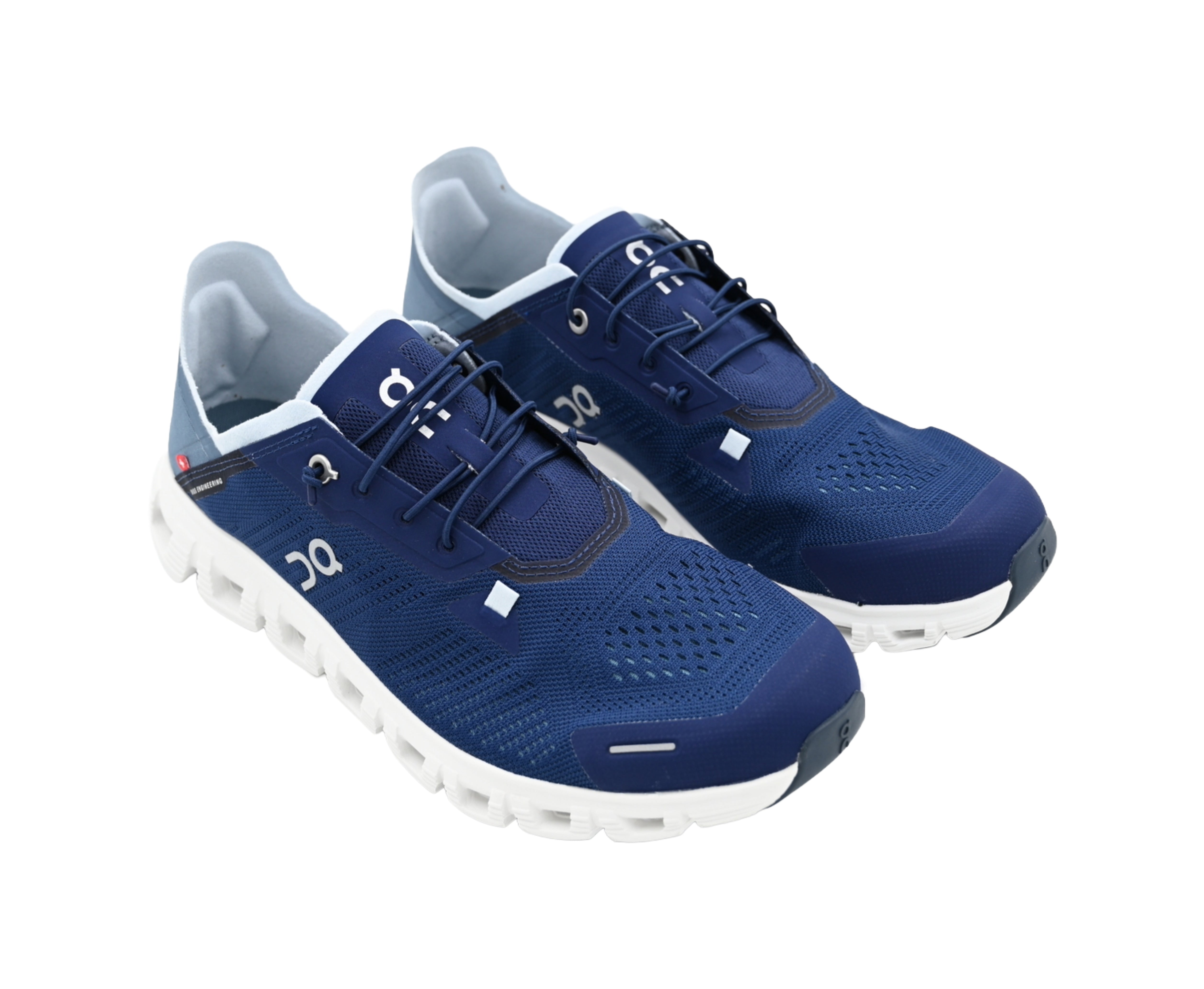 Pair of blue running shoes with white soles on a white background