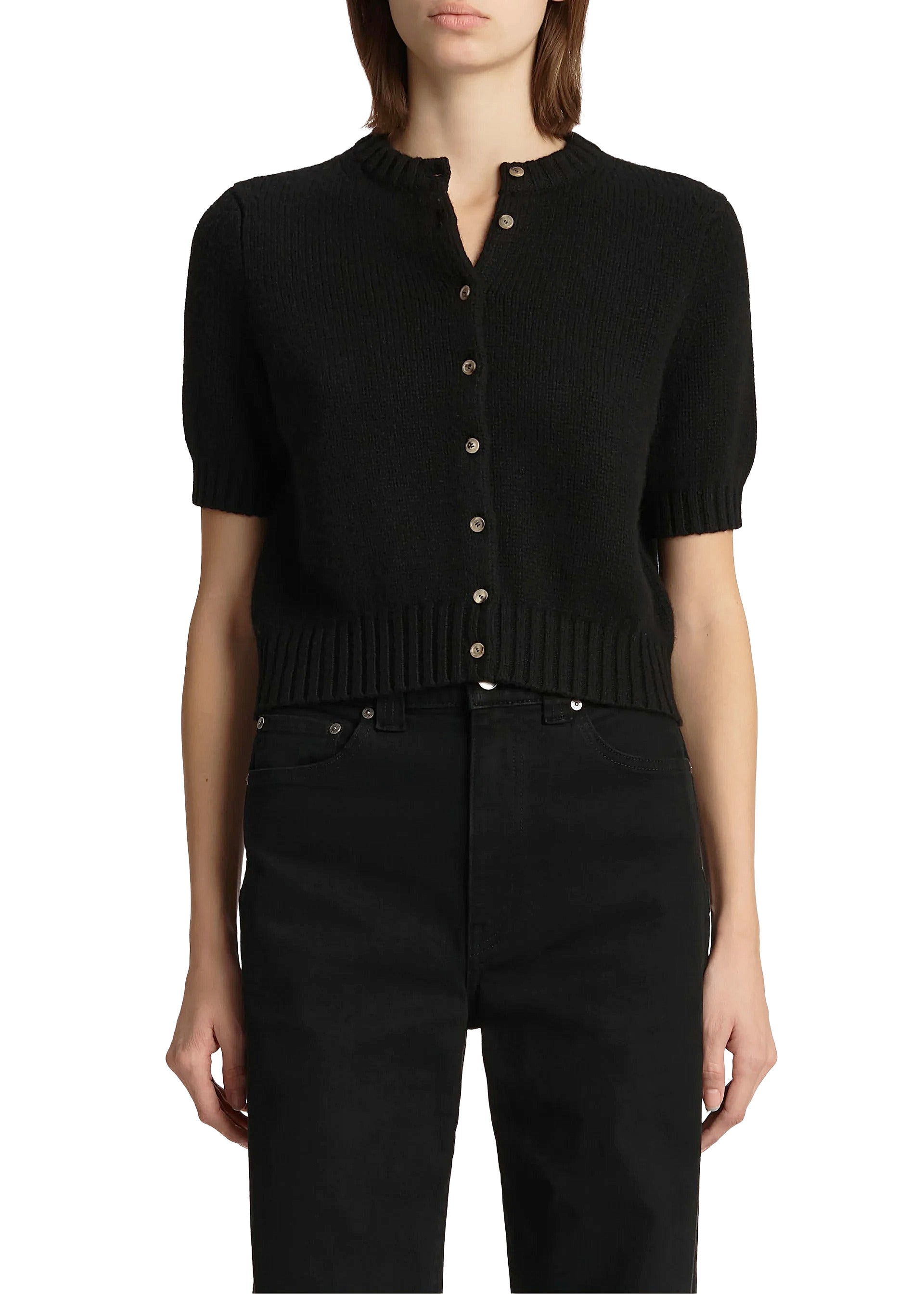 Person wearing a black short-sleeve cardigan with buttons on a white background