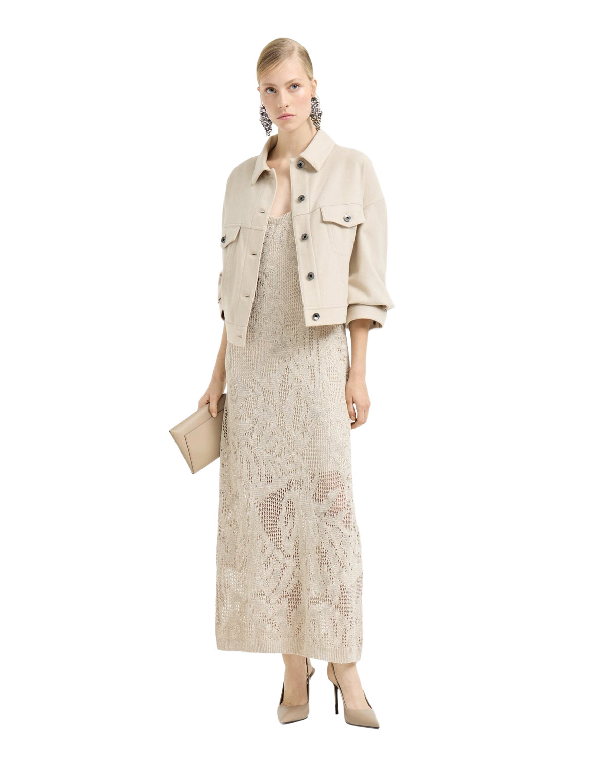 Woman wearing a beige jacket and dress on a white background
