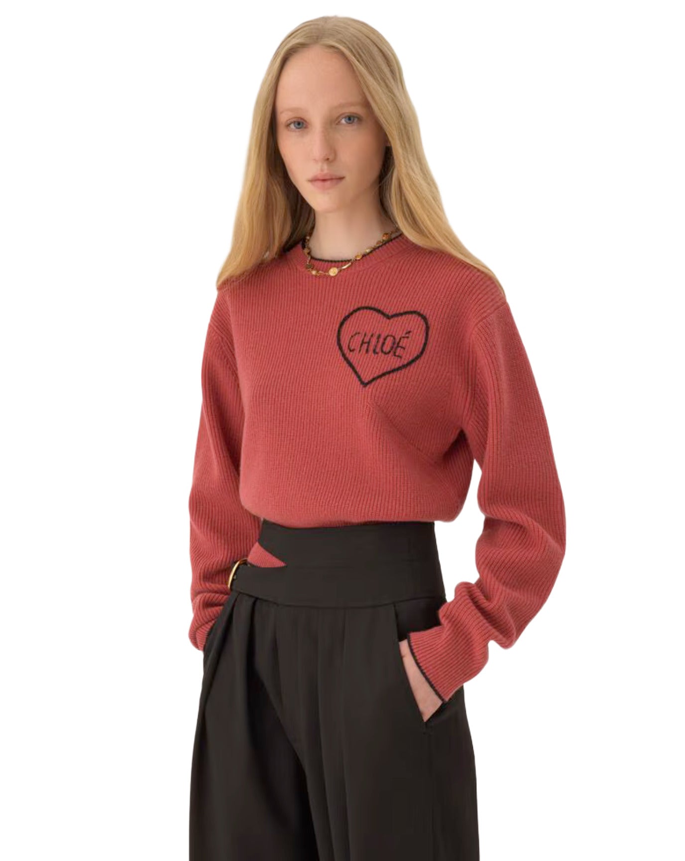 Person wearing a red sweater with a heart design on a white background
