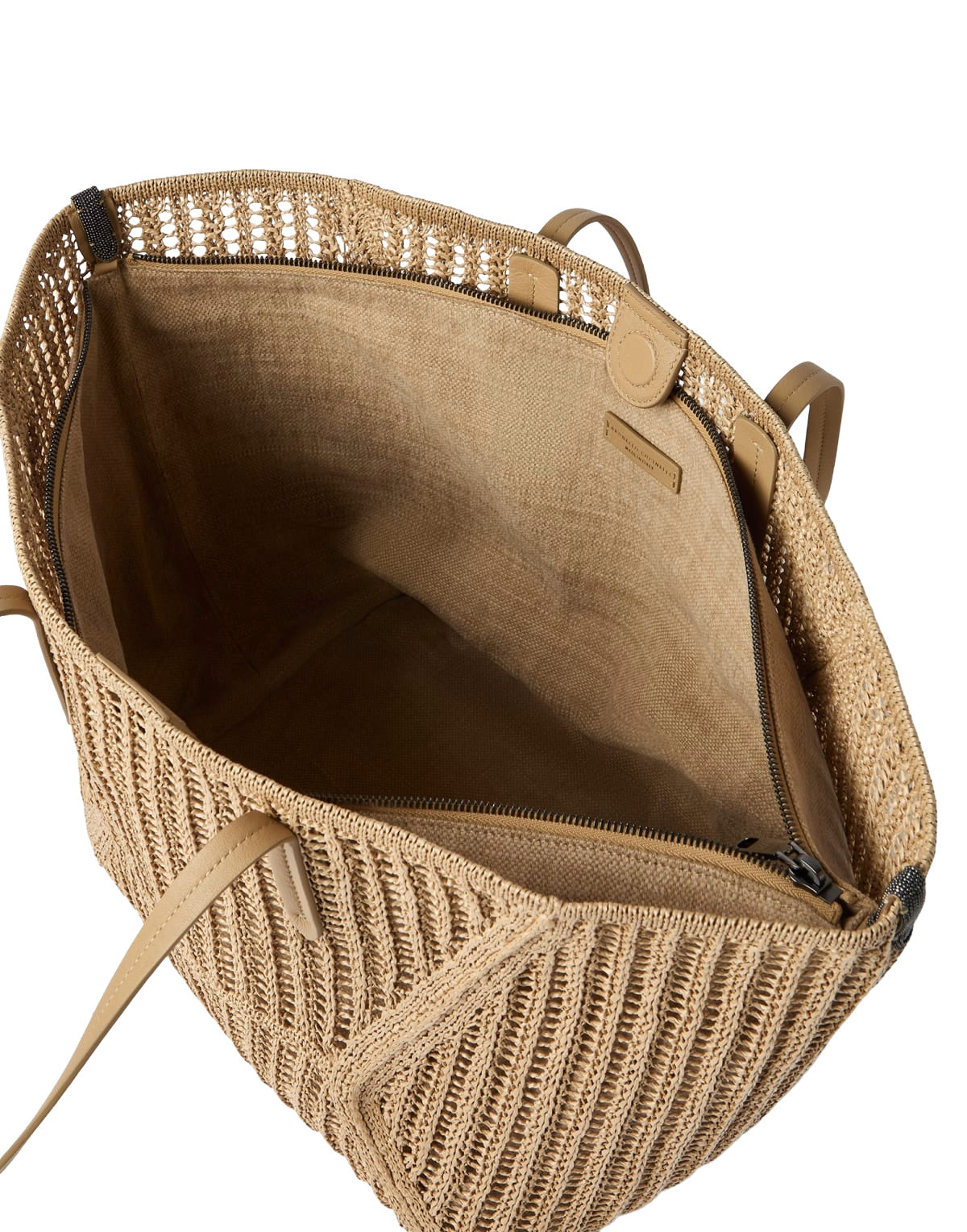 Open beige woven bag with a visible brand label on a white background