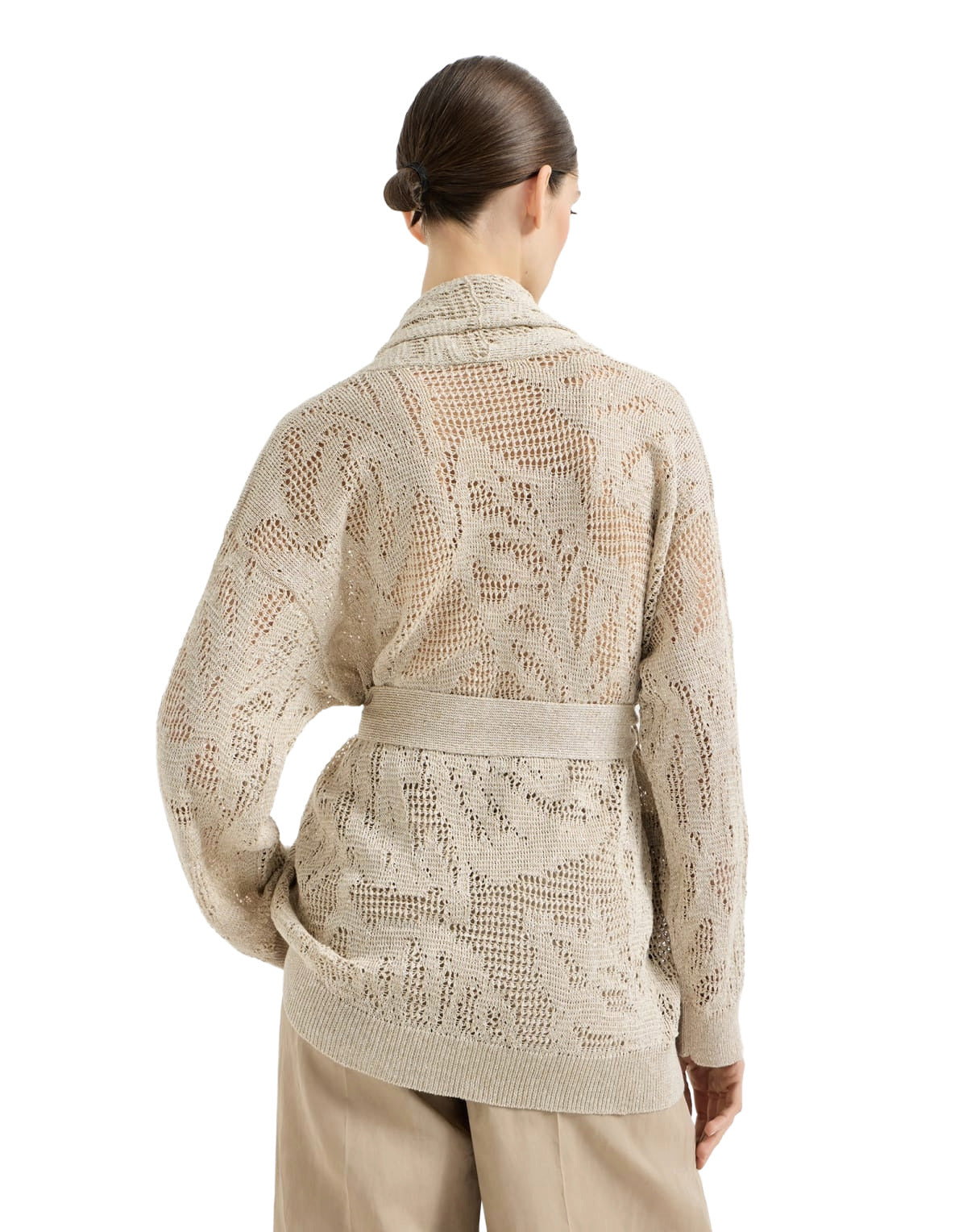 Woman wearing a beige patterned jacket on a white background