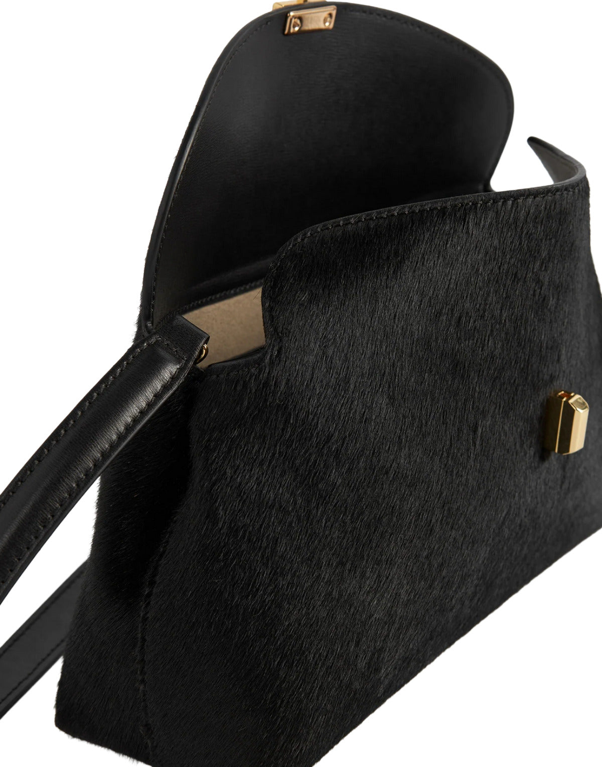 Black cowhide handbag with gold hardware on a white background